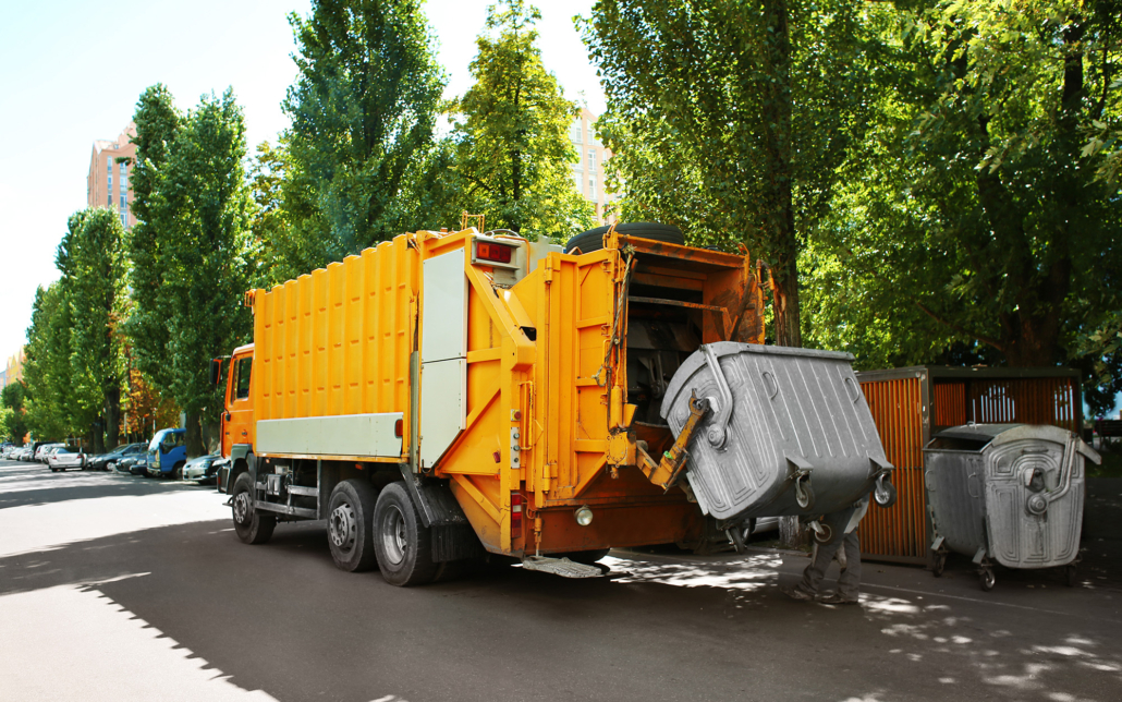 Garbage Truck Emptying Dumpster