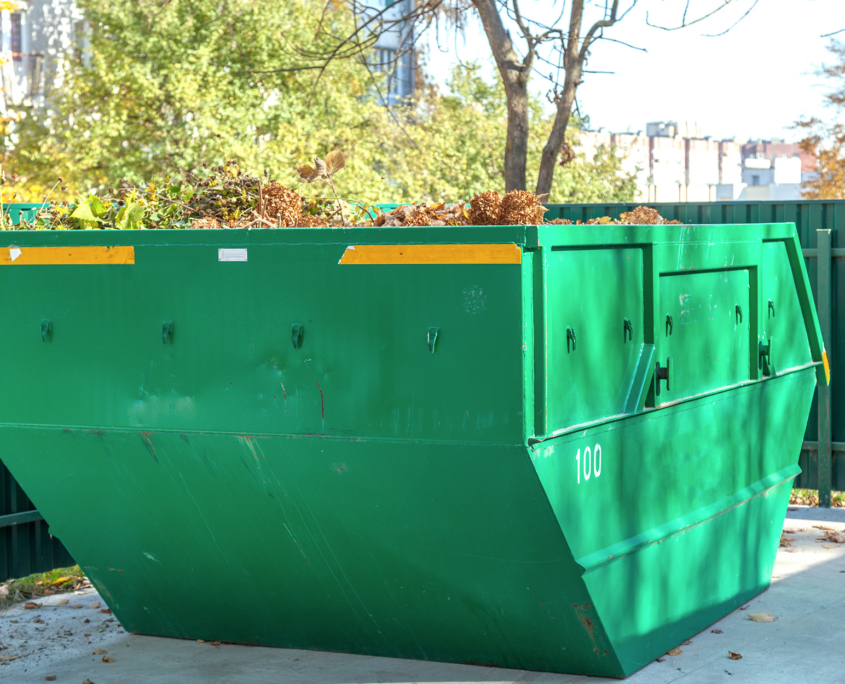 Large Dumpster In Parking Lot Of Senior Living Facility