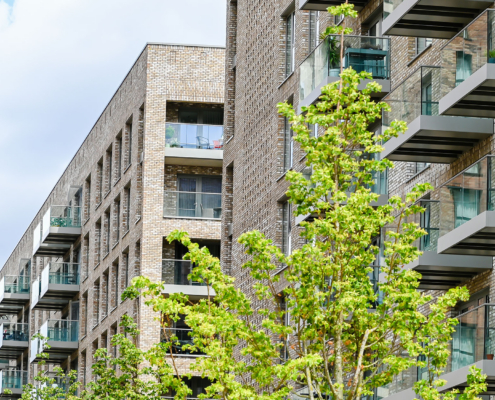 Modern Apartment Building With Balconies And Blue Sky